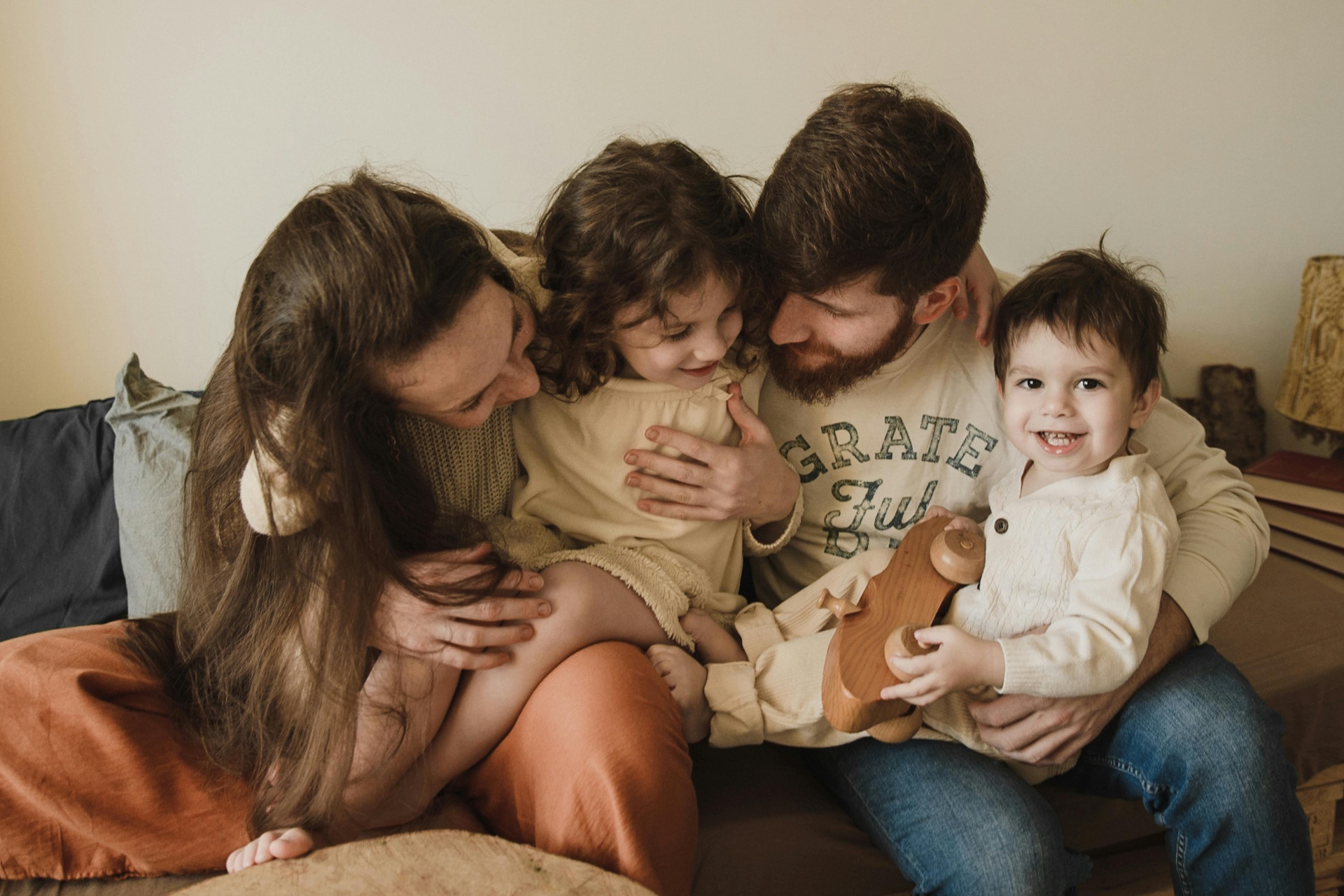 Family embracing on a couch